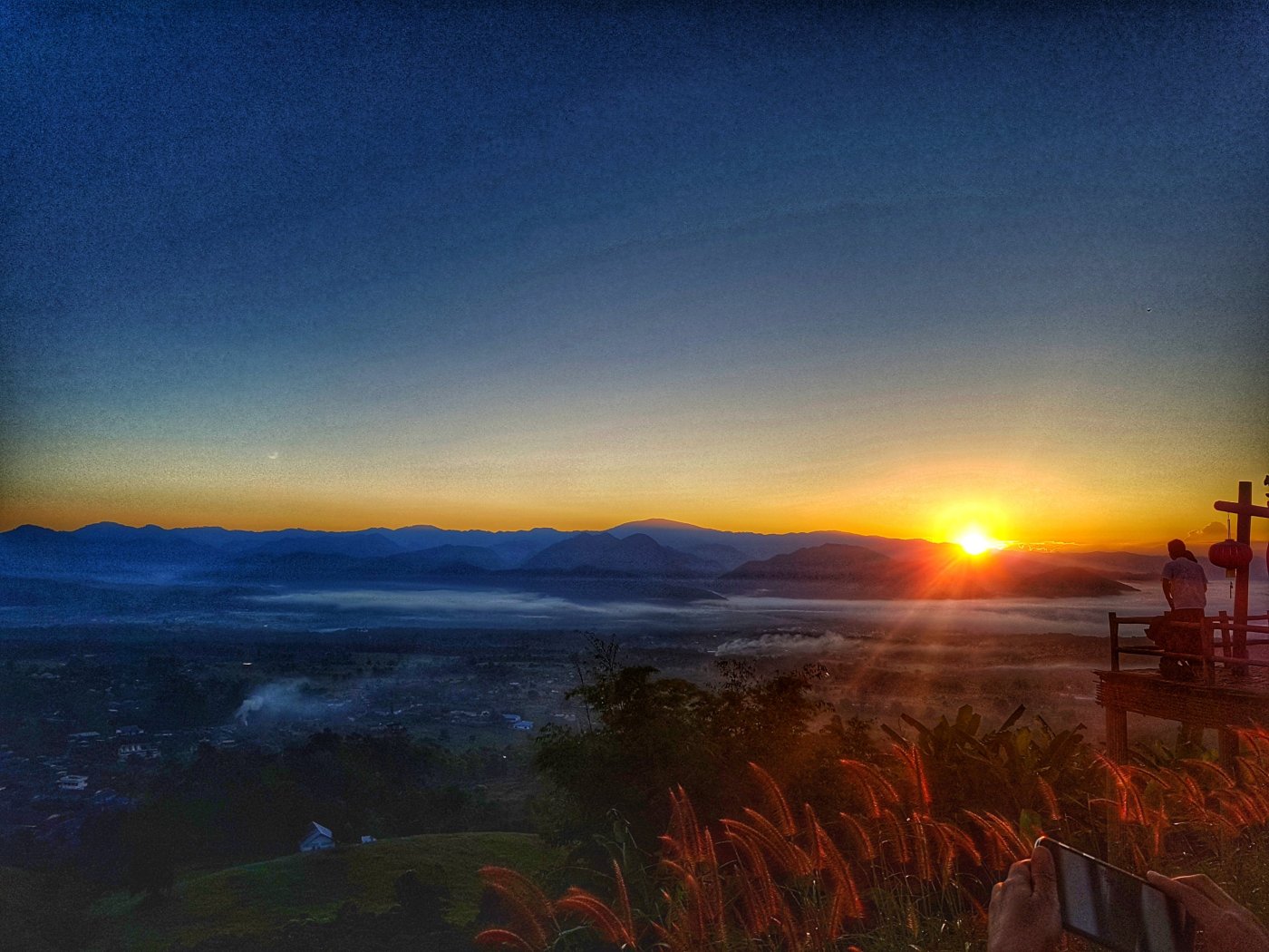 Sun rises over Pai in the valley below