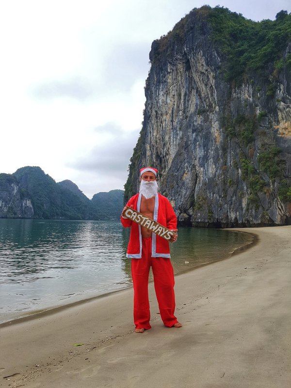 Calum dressed in a farther Christmas outfit on Castaways, Ha Long Bay