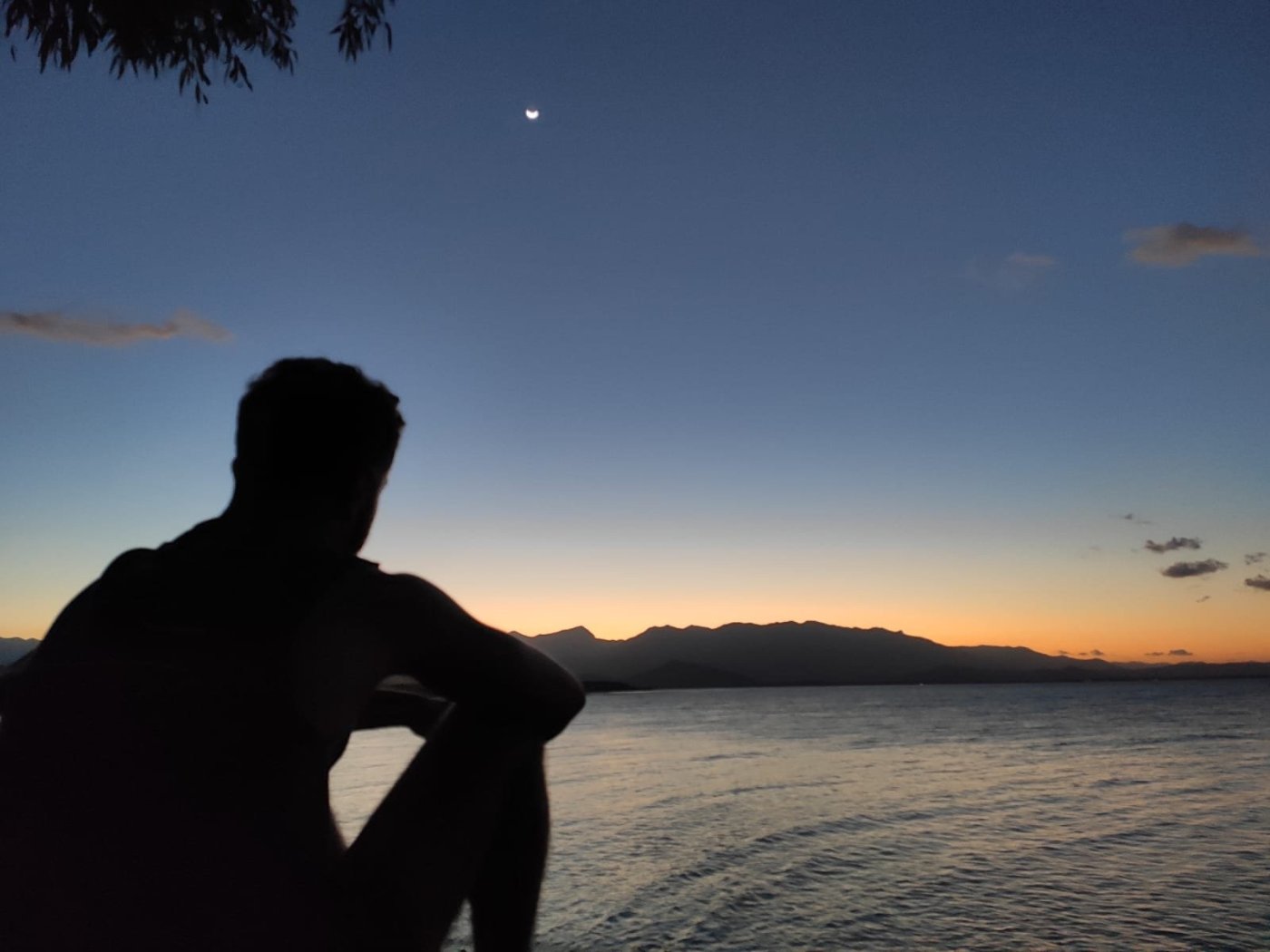 Calum in the foreground of a sunset at Port Douglas