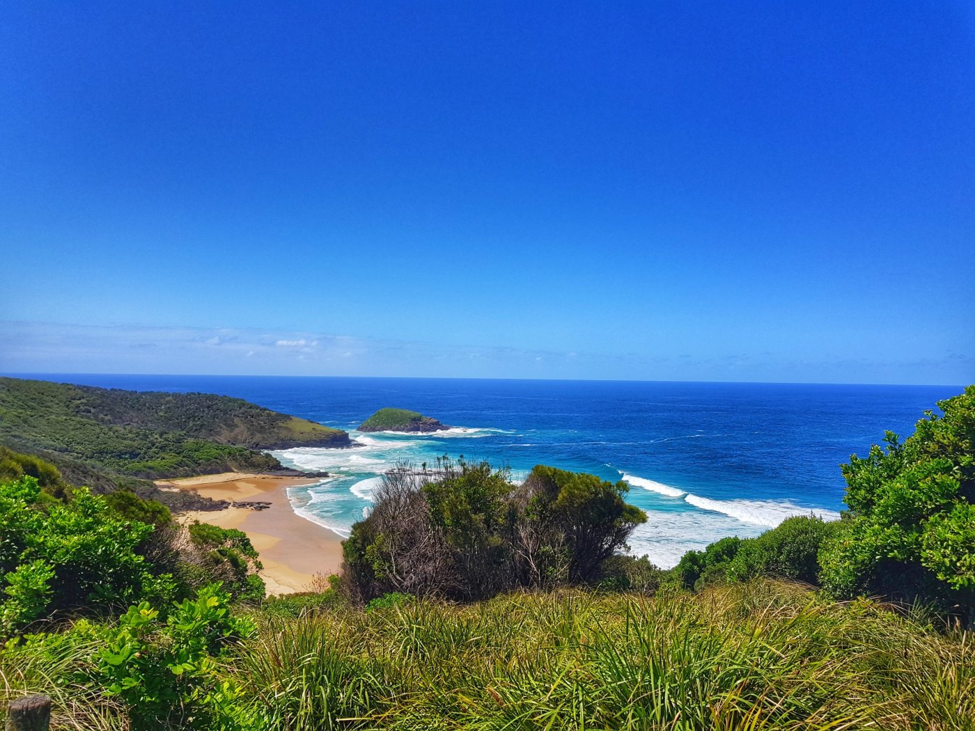 Panoramic views of North Smokey Beach with clear blue skies