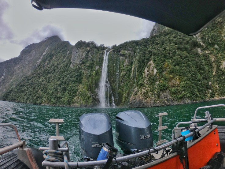 Twin 250 boat engines with the backdrop of a waterfall in Milford Sound