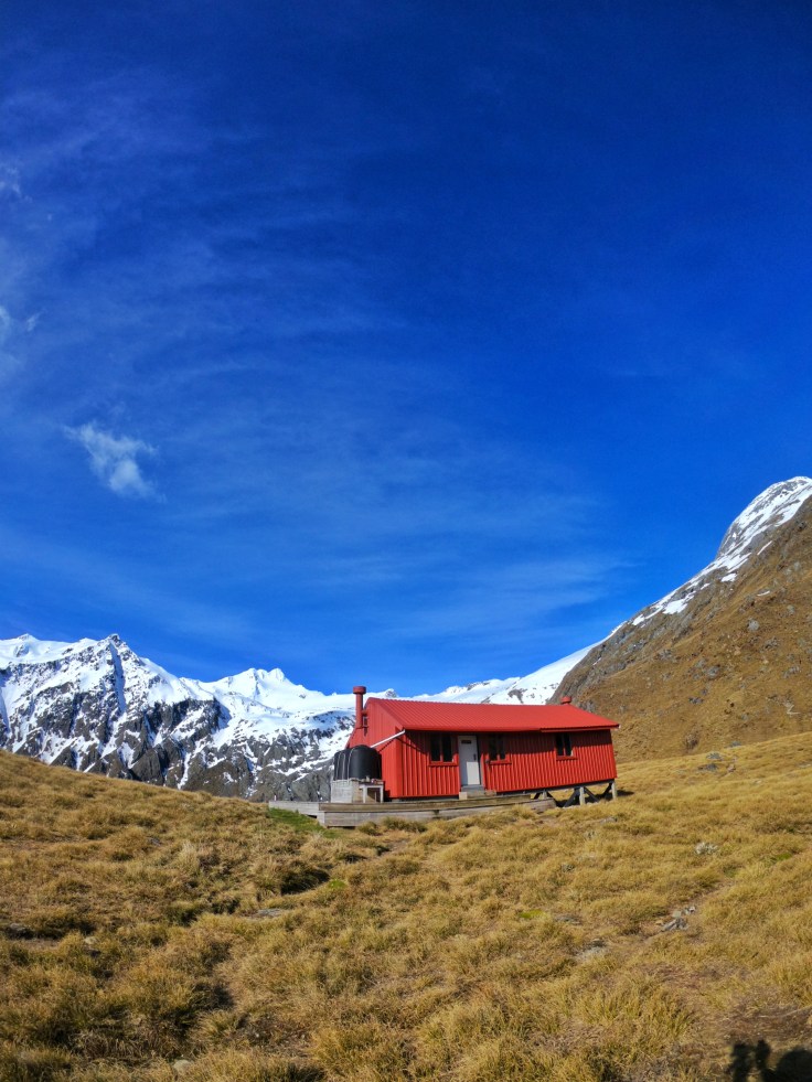 Brewster hut on a clear sunny day, with Mt Brewster in the background