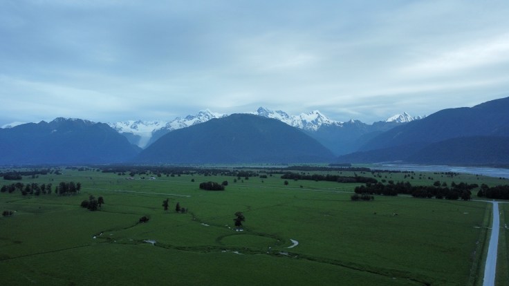 Distant drone shot of Fox Glacier, Mt Cook & Tasman