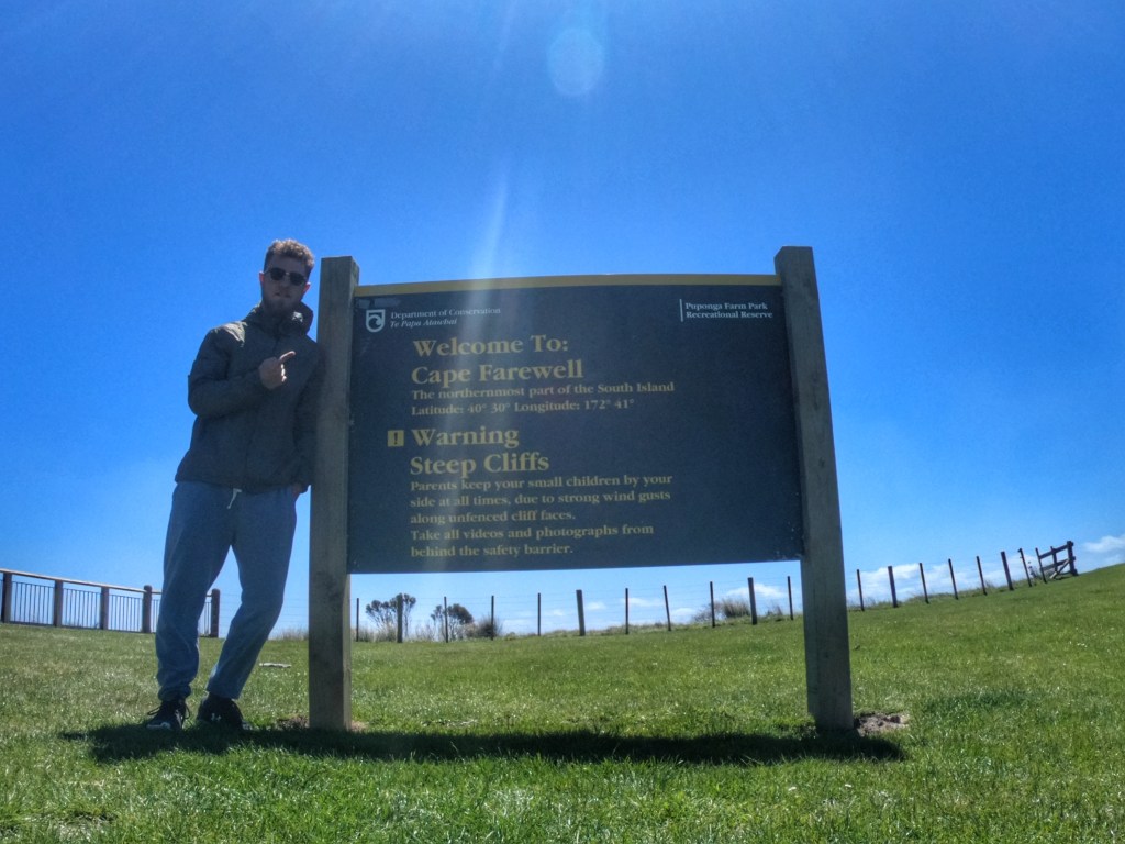 Calum Everitt at the Cape Farewell sign NZ