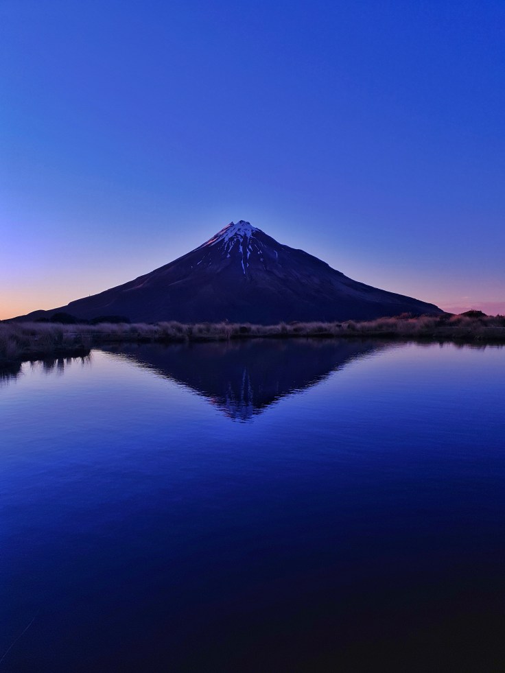 Mt Taranaki at sunrise in reflecting Pouakai Tarn