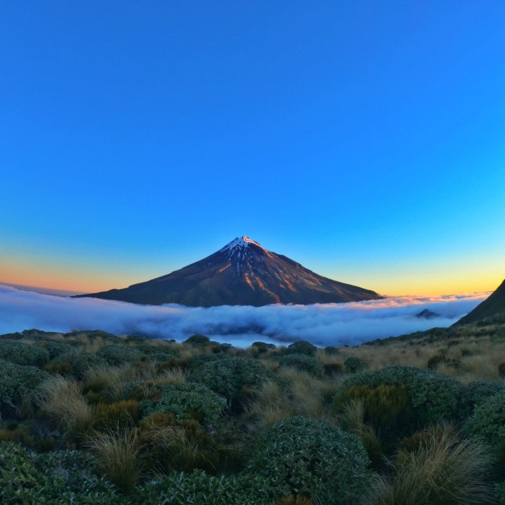 Mt Taranaki at sunset with low hanging cloud in the valley