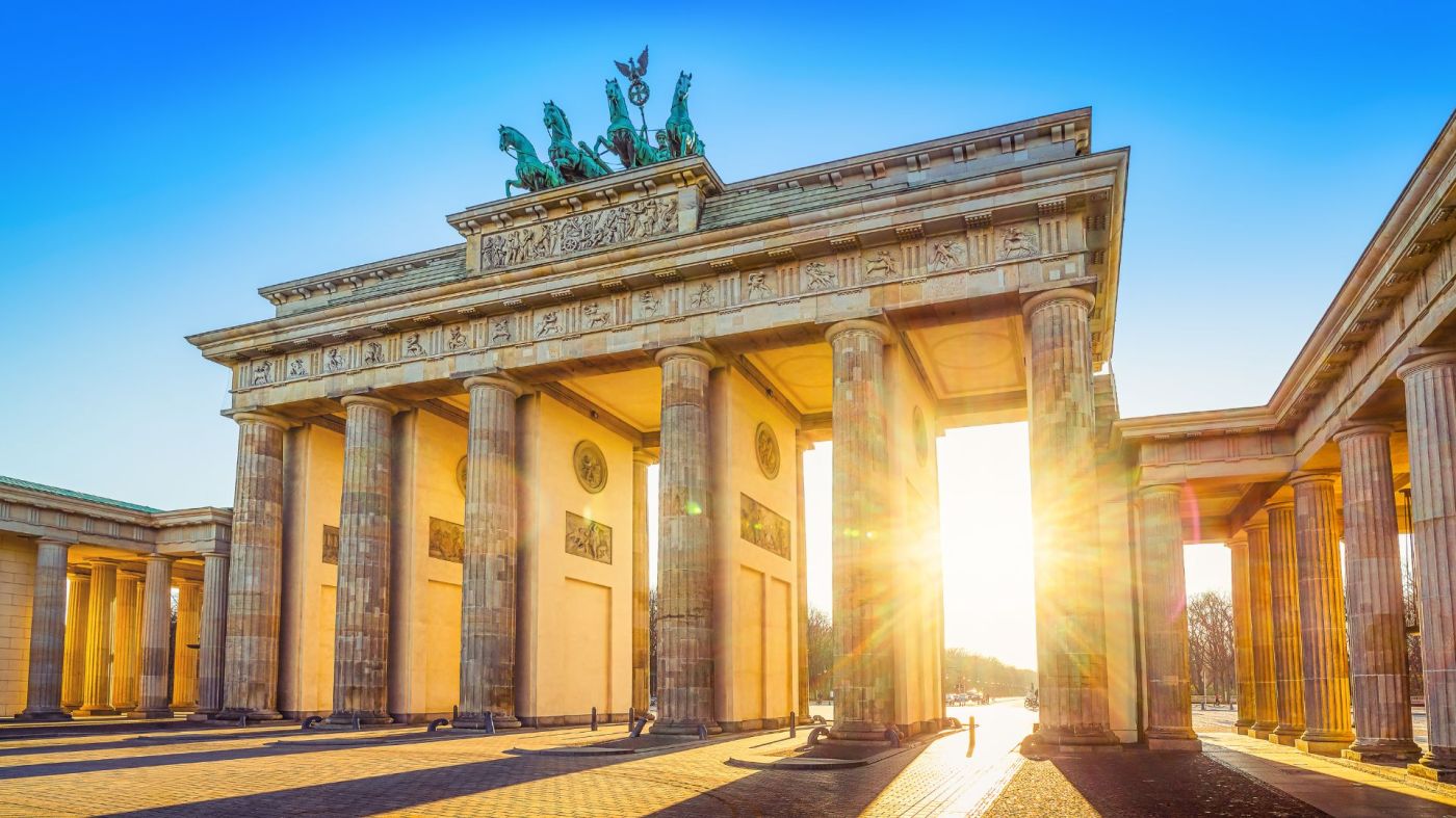 Sun streaks through Brandenburg Gate Berlin