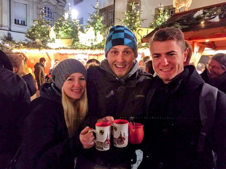 3 friends drink Gluhwein at Stuttgart Christmas market
